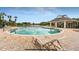 Inviting community pool with lounge chairs, clear blue skies, and a beautiful pool house at 7113 52Nd E Dr, Bradenton, FL 34203
