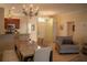 Inviting dining area featuring a modern light fixture and easy access to the kitchen and living spaces at 7113 52Nd E Dr, Bradenton, FL 34203