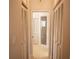 Hallway leading to bathroom with linen closets and a glass door shower at 7113 52Nd E Dr, Bradenton, FL 34203
