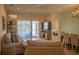 Cozy living room with a plush sofa, neutral colors, and sliding glass doors leading to the pool at 7113 52Nd E Dr, Bradenton, FL 34203