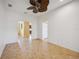 Neutral tile flooring, light walls, and a ceiling fan providing access and connection to other areas at 7339 Birds Eye Ter, Bradenton, FL 34203