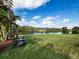 Beautiful backyard with lake view and Adirondack chairs perfect for relaxation at 8284 Barton Farms Blvd, Sarasota, FL 34240
