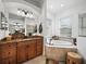 Beautiful bathroom features separate vanities, soaking tub and tiled shower at 8284 Barton Farms Blvd, Sarasota, FL 34240