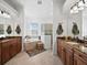 Bathroom featuring separate vanities, soaking tub, and tiled shower at 8284 Barton Farms Blvd, Sarasota, FL 34240