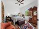 This bright bedroom features a ceiling fan, a window, wood floors, and accent furniture at 8284 Barton Farms Blvd, Sarasota, FL 34240
