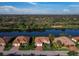Stunning aerial view of homes along the waterway, showcasing lush landscaping and tile roofs at 8284 Barton Farms Blvd, Sarasota, FL 34240
