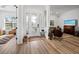 Bright foyer featuring wood floors, a decorative glass door, and views into the living areas at 8284 Barton Farms Blvd, Sarasota, FL 34240