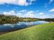 Scenic view of the lake with blue skies, fluffy clouds, and grass at 8284 Barton Farms Blvd, Sarasota, FL 34240