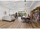 Spacious and bright living area features wood floors, dining area, and lake views at 8284 Barton Farms Blvd, Sarasota, FL 34240