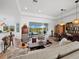 Spacious living area with wood floors, comfortable seating, and panoramic views of the lake at 8284 Barton Farms Blvd, Sarasota, FL 34240