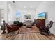 Bright and spacious living room features wood floors, a large window, and comfortable seating at 8284 Barton Farms Blvd, Sarasota, FL 34240
