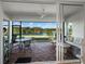 Covered patio with comfortable seating, a ceiling fan, and serene views of the lake at 8284 Barton Farms Blvd, Sarasota, FL 34240