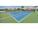 Enjoy a game on this well-maintained tennis court with lush green surroundings and lake views at 8284 Barton Farms Blvd, Sarasota, FL 34240
