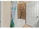 Bathroom featuring a shower and tub combination with tiled walls and a curtain with a colorful, vibrant design at 9043 39Th Street E Cir, Parrish, FL 34219