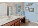 Bright bathroom with a vanity, sink, mirror, toilet, and shower featuring nautical decor and a calming color scheme at 9043 39Th Street E Cir, Parrish, FL 34219