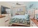 Comfortable bedroom with tropical decor, a large bed, ceiling fan, and ample closet space at 9043 39Th Street E Cir, Parrish, FL 34219