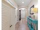 Inviting hallway with neutral walls, tiled flooring, and stylish console table at 9043 39Th Street E Cir, Parrish, FL 34219