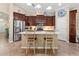 Well-lit kitchen features brown cabinets, stainless steel appliances, and a central island with countertop seating at 9043 39Th Street E Cir, Parrish, FL 34219