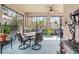Inviting screened lanai featuring a dining area, ceiling fan, and views of the surrounding landscape at 9043 39Th Street E Cir, Parrish, FL 34219