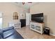 Spare living room featuring neutral decor, tile flooring, and a large television with stylish console at 9043 39Th Street E Cir, Parrish, FL 34219