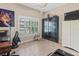 Office with a large window, tile flooring, and a combination of dark and light furniture at 9043 39Th Street E Cir, Parrish, FL 34219