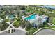 Aerial view of a community center featuring a pool, playground, and lush landscaping at 11231 Woodlake Way, Parrish, FL 34219