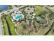 An overhead view featuring a community pool, park, sports facilities, and clubhouse at 11231 Woodlake Way, Parrish, FL 34219