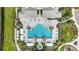 Aerial shot of a luxurious pool area, complete with ample seating and lush landscaping at 11231 Woodlake Way, Parrish, FL 34219