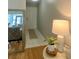 Inviting entryway with white door and tile floors, complemented by a decorative table and plant at 1129 Montrose Pl, Dunedin, FL 34698