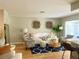 Bright living room featuring a comfortable sofa, decorative rug, and stylish decor at 1129 Montrose Pl, Dunedin, FL 34698