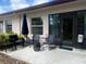 The patio has a table, chairs, umbrella, and a sliding glass door at 1129 Montrose Pl, Dunedin, FL 34698