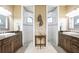 Modern bathroom featuring dual sinks, granite countertops, and two separate glass-enclosed showers at 1129 Rotonda Cir, Rotonda West, FL 33947