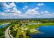 Breathtaking aerial view of a golf course and lake with clear blue skies at 11728 Strandhill Ct, Lakewood Ranch, FL 34202