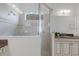 Elegant bathroom featuring a glass enclosed shower and vanity with granite counter at 11728 Strandhill Ct, Lakewood Ranch, FL 34202