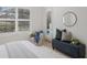 Bright bedroom with plantation shutters and a cushioned ottoman for seating at 11728 Strandhill Ct, Lakewood Ranch, FL 34202