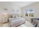 Serene bedroom featuring neutral tones, plantation shutters, and a plush rug at 11728 Strandhill Ct, Lakewood Ranch, FL 34202