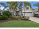 Charming home with manicured lawn, lush landscaping, and a two-car garage at 11728 Strandhill Ct, Lakewood Ranch, FL 34202