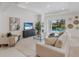 Bright living room featuring tile floors, large sectional sofa and access to a screened pool area at 11728 Strandhill Ct, Lakewood Ranch, FL 34202