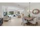 Open-concept living space featuring a dining area and a living room with seamless access to the outdoor pool area at 11728 Strandhill Ct, Lakewood Ranch, FL 34202