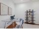 Bright office space with modern glass desk and stylish shelving at 11728 Strandhill Ct, Lakewood Ranch, FL 34202