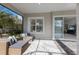 Cozy covered patio with comfortable seating, offering a relaxing outdoor living space and a view of the home at 11728 Strandhill Ct, Lakewood Ranch, FL 34202
