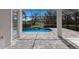 Screened-in patio featuring a brick floor that leads to a pool and beautiful backyard at 11728 Strandhill Ct, Lakewood Ranch, FL 34202