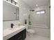 Modern bathroom with black and white tiling, walk-in shower, and contemporary vanity with stylish mirror at 1471 Palmwood Dr, Sarasota, FL 34232