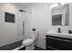 Contemporary bathroom featuring textured tiling, black fixtures, glass shower, and modern black vanity at 1471 Palmwood Dr, Sarasota, FL 34232