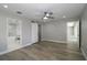 A spacious bedroom is adjacent to the bathroom with hardwood floors and neutral wall tones at 1471 Palmwood Dr, Sarasota, FL 34232