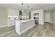 Bright, modern kitchen with white cabinets, stainless steel appliances, and a large island at 1471 Palmwood Dr, Sarasota, FL 34232