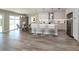 Open-concept kitchen and living area with hardwood floors and natural light at 1471 Palmwood Dr, Sarasota, FL 34232
