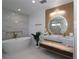 Elegant primary bathroom with soaking tub, dual sinks, and modern lighting at 1471 Palmwood Dr, Sarasota, FL 34232