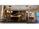 The kitchen boasts a granite countertop, stainless steel refrigerator, custom cabinets, and stylish pendant lighting at 1521 67Th Street E Ct, Bradenton, FL 34208