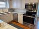 Bright kitchen with white cabinets, stainless steel appliances, and a window above the sink at 1675 7Th St, Sarasota, FL 34236